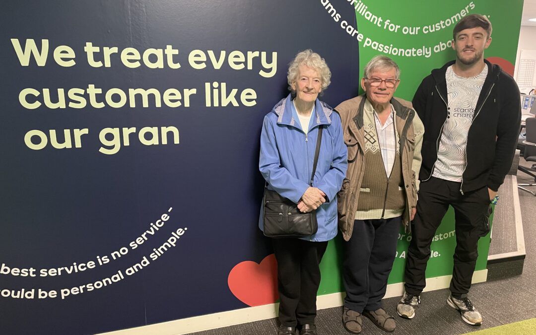 Customers Brenda and Alan Huby at the AO headquarters in Bolton, with assistant sales manager Connor Eckersley