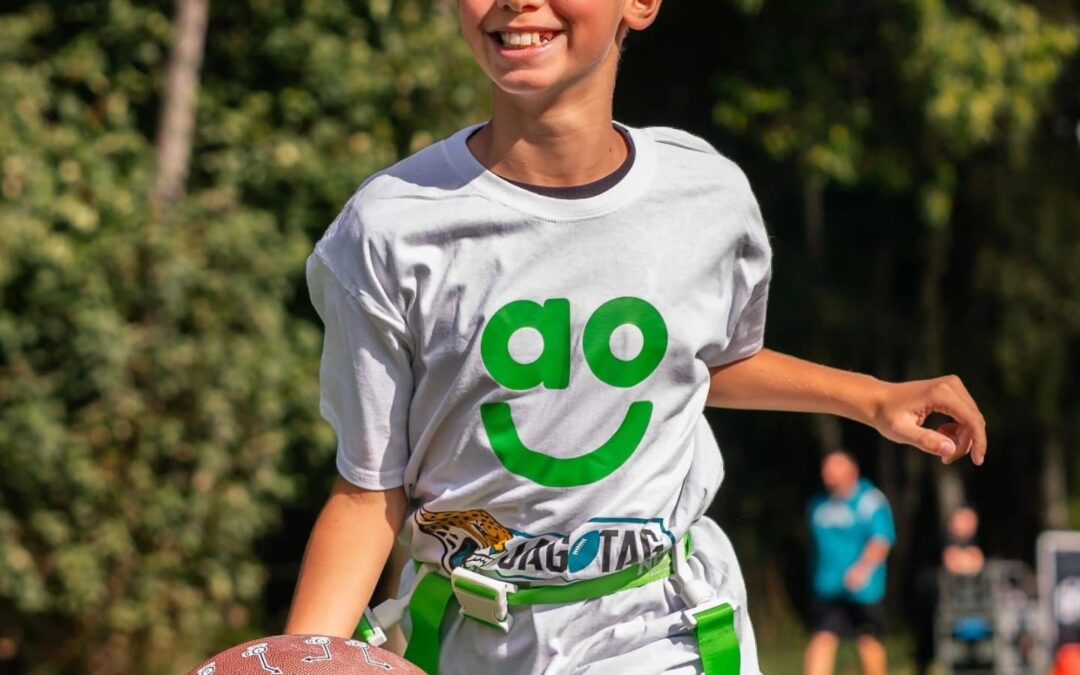 A child playing JagTag in an AO-branded top